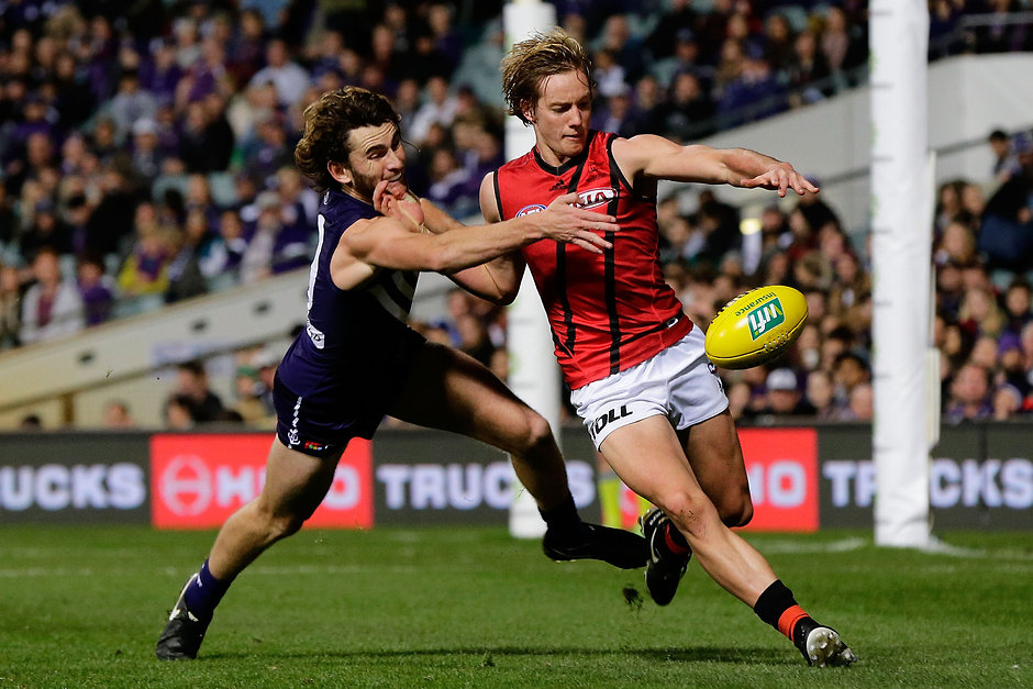 AFL 2016 Rd 11 - Fremantle v Essendon PERTH, AUSTRALIA - JUNE 04: Will Hams of the Bombers kicks the ball under pressure from Connor Blakely of the Dockers during the 2016 AFL Round 11 match between the Fremantle Dockers and the Essendon Bombers at Domain Stadium on June 4, 2016 in Perth, Australia. (Photo by Will Russell/AFL Media)